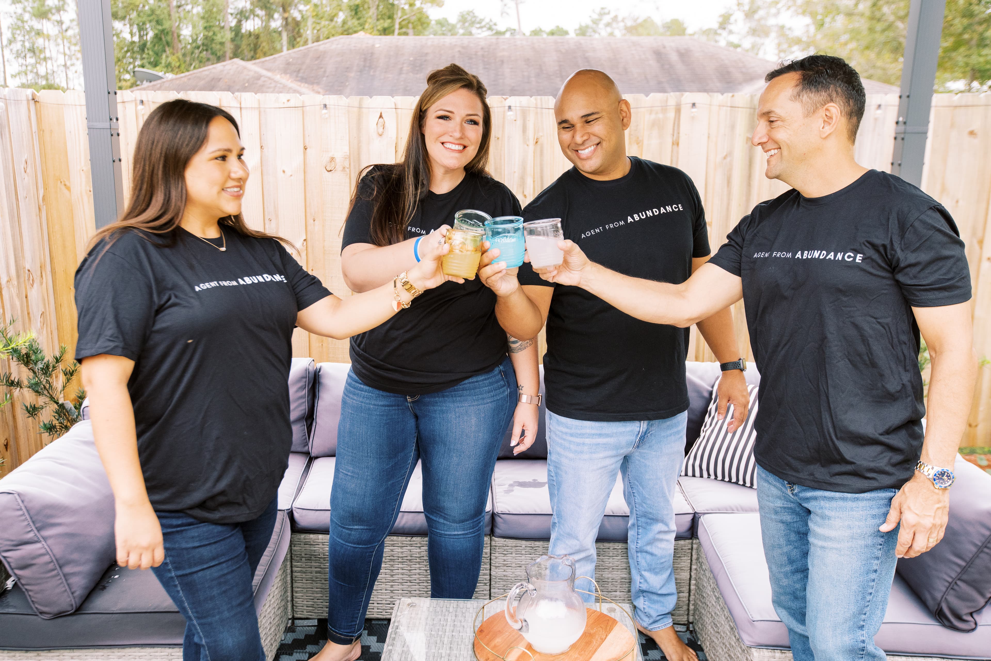 Four people holding a drink